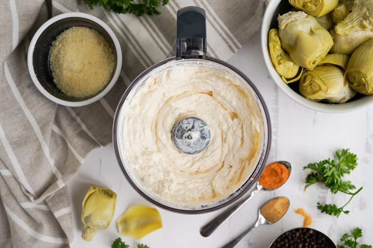 food processor with blended artichoke dip