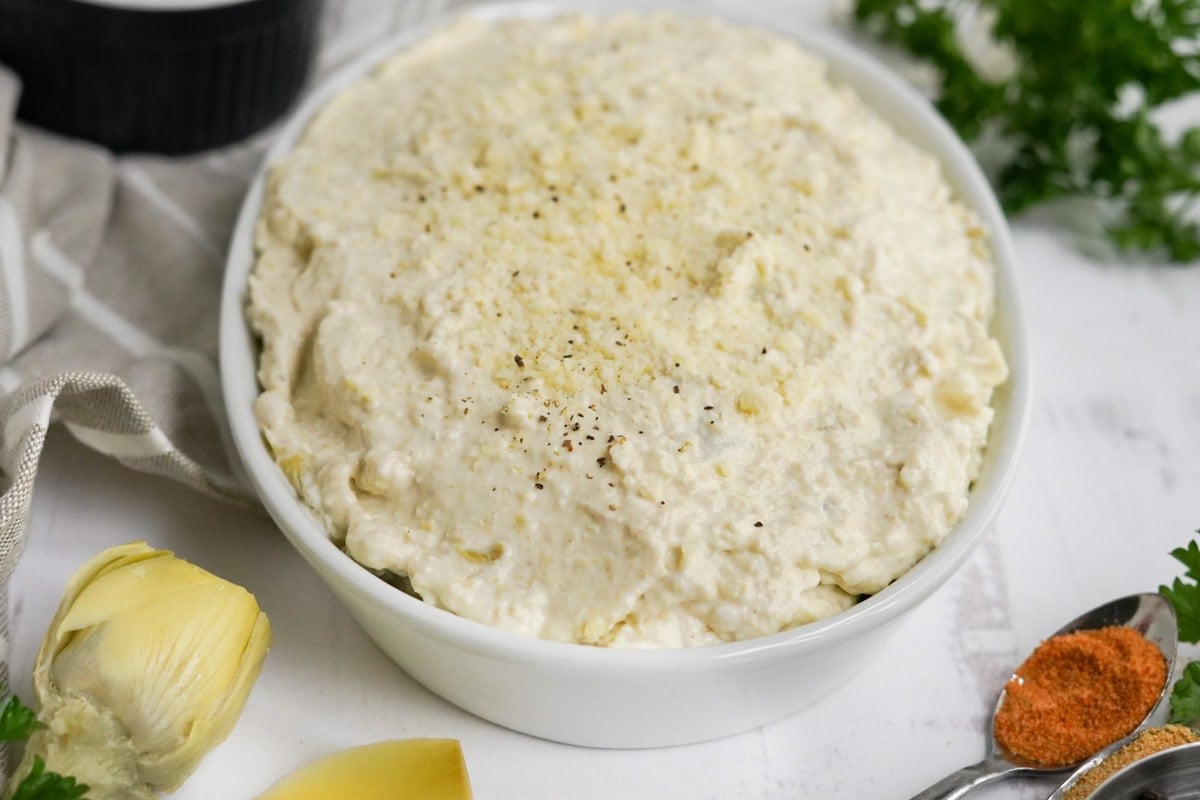 artichoke dip in a dish before baking