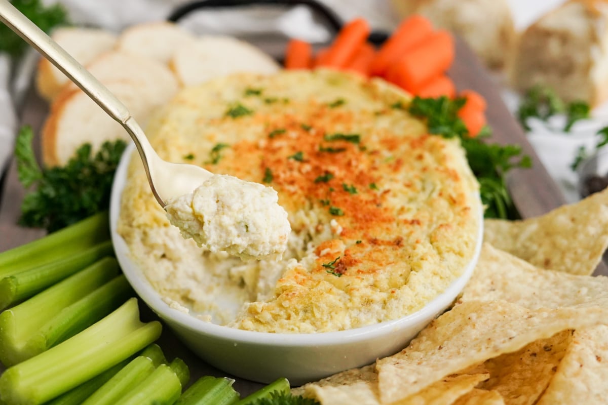 baked artichoke dip on a spoon