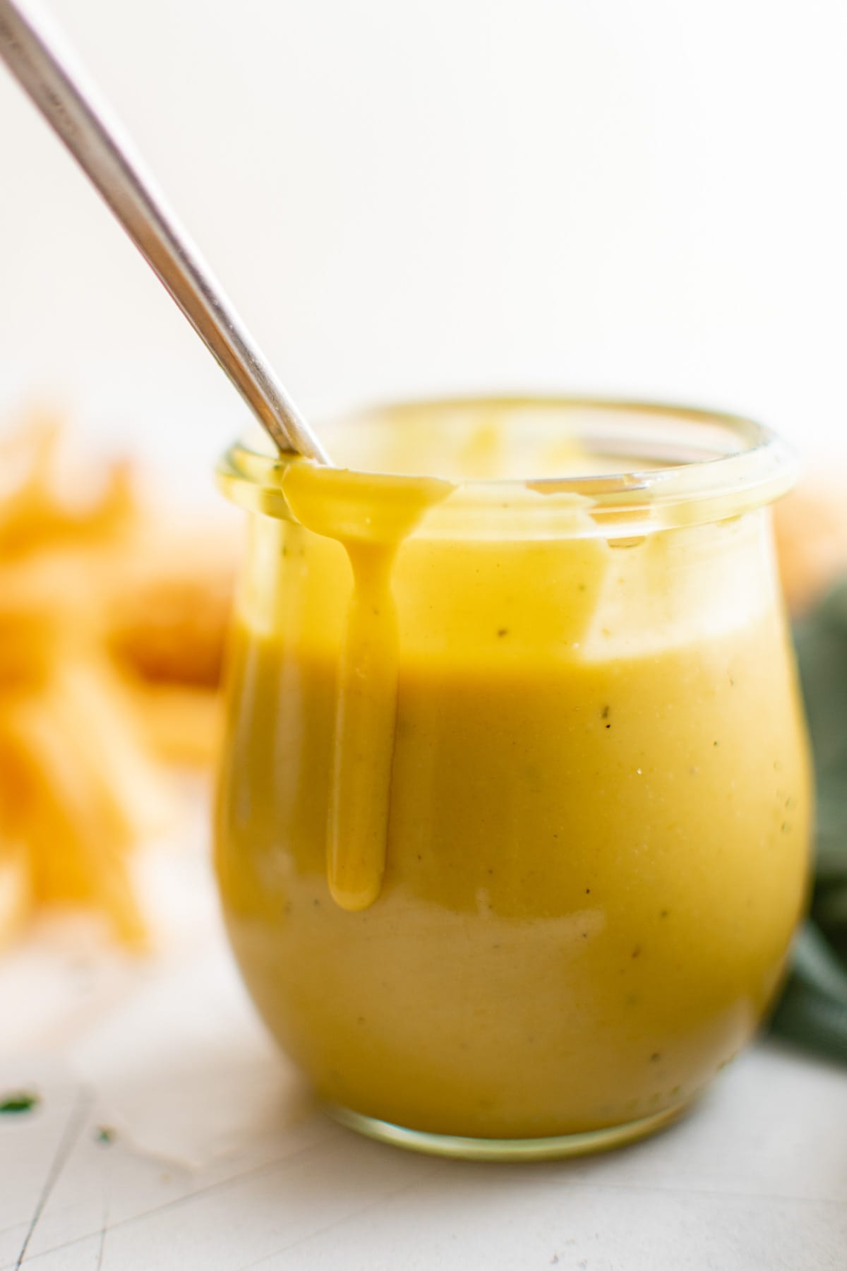 jar of honey mustard sauce with a spoon