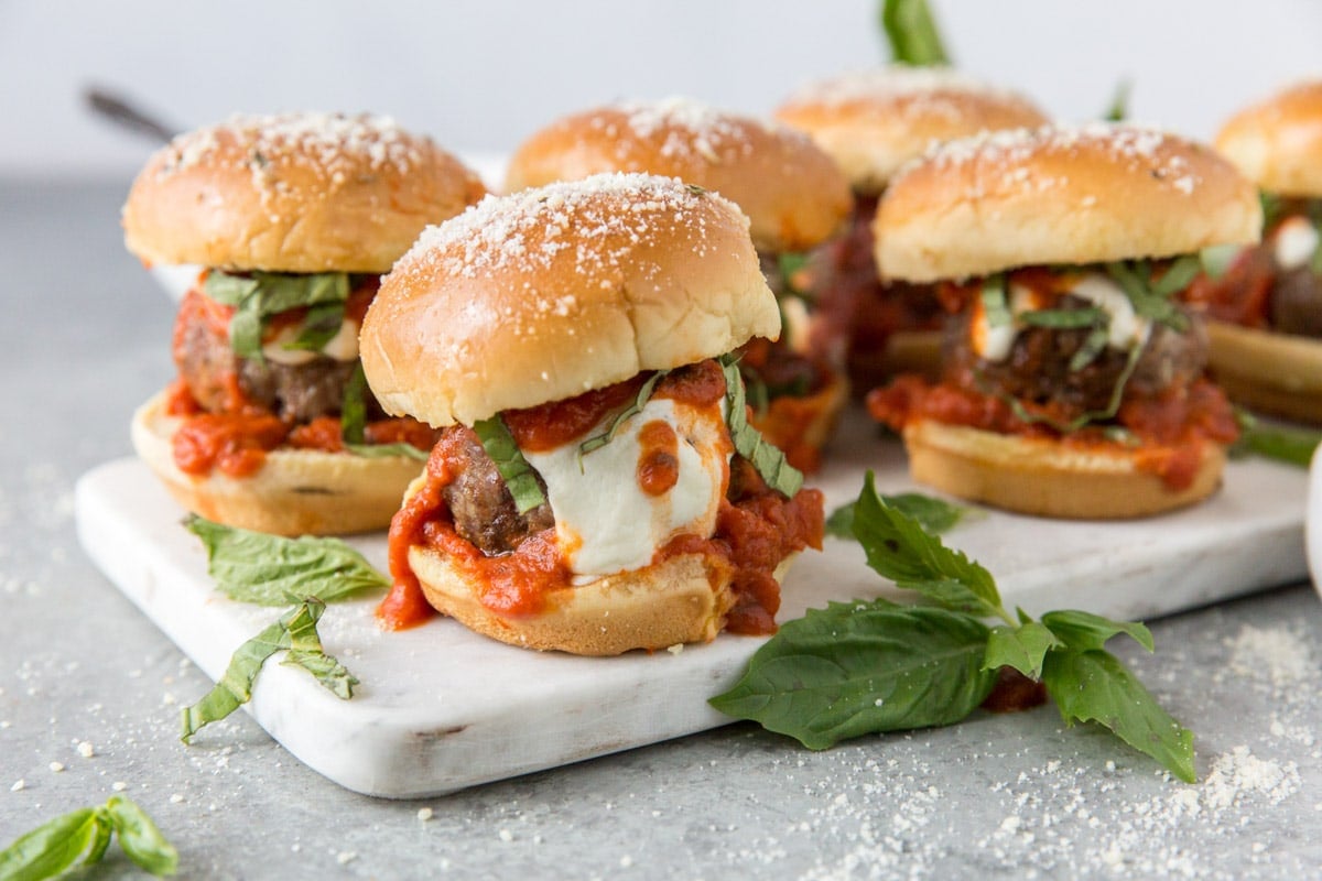 meatballs on slider rolls with cheese and marinara sauce