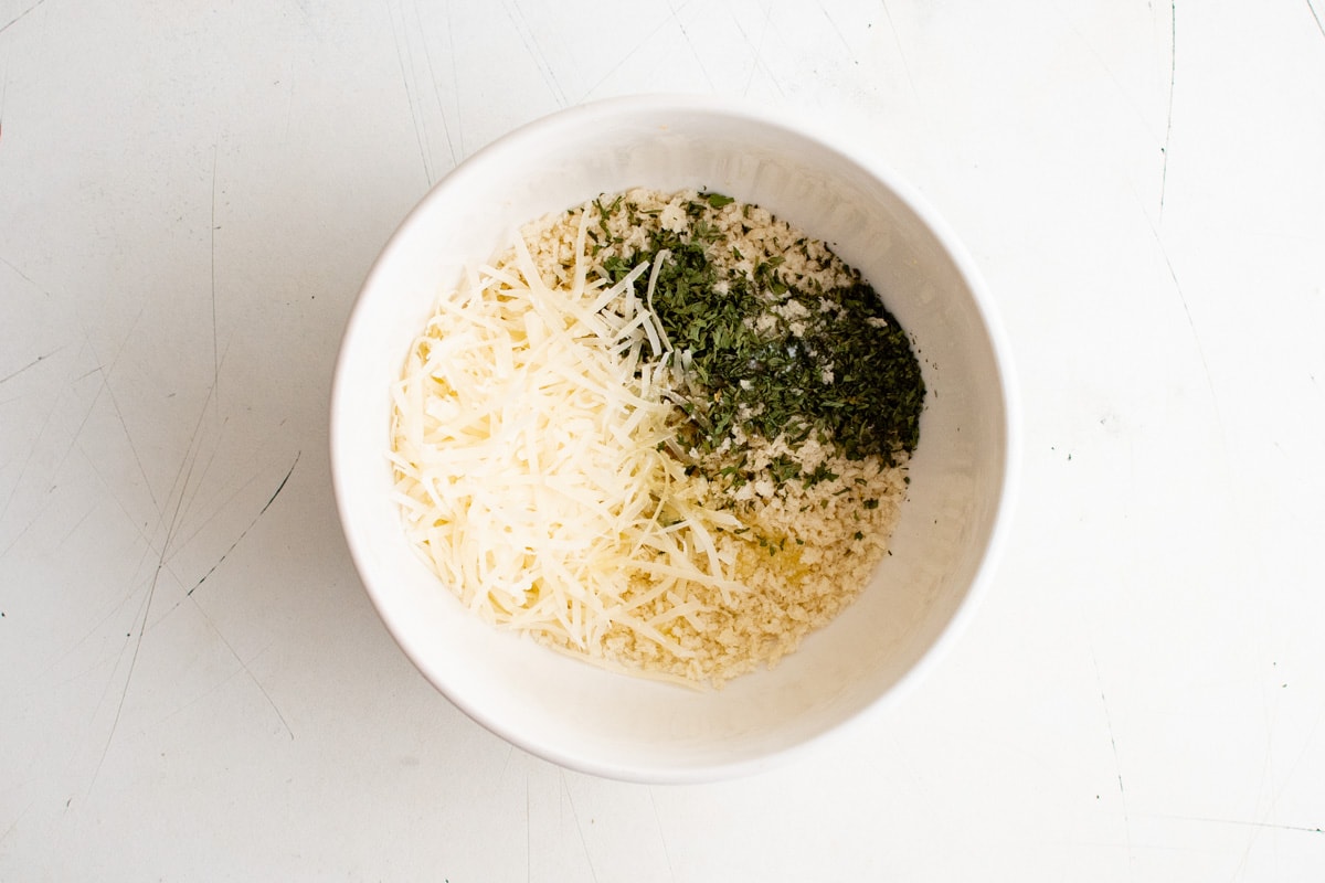 Parmesan cheese, breadcrumbs and parsley in a small bowl