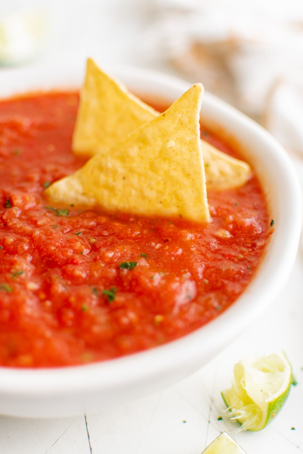 bowl of salsa with tortilla chips in it