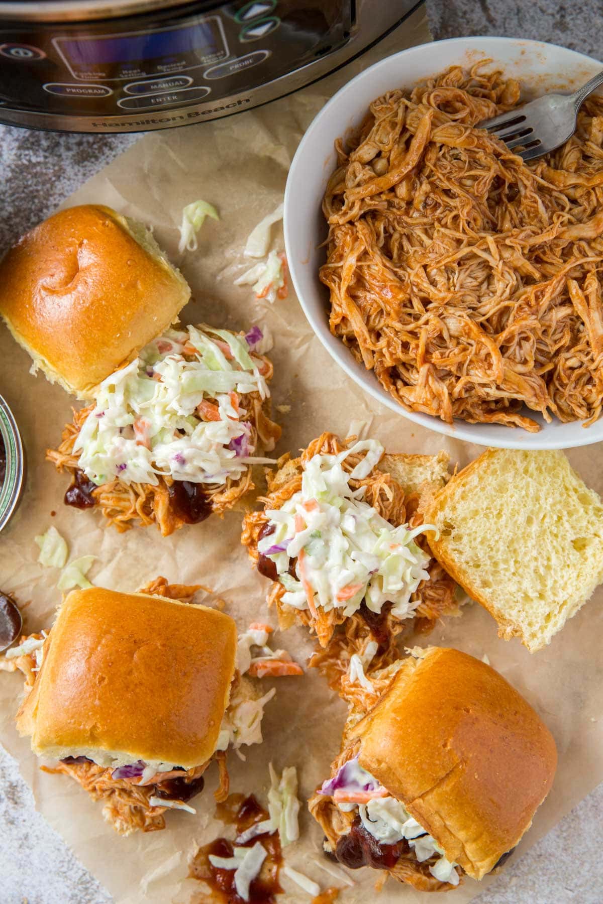 overhead shot of slider buns with shredded bbq chicken and coleslaw