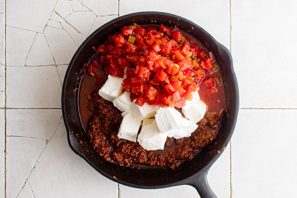 chorizo, tomatoes and cream cheese in a skillet