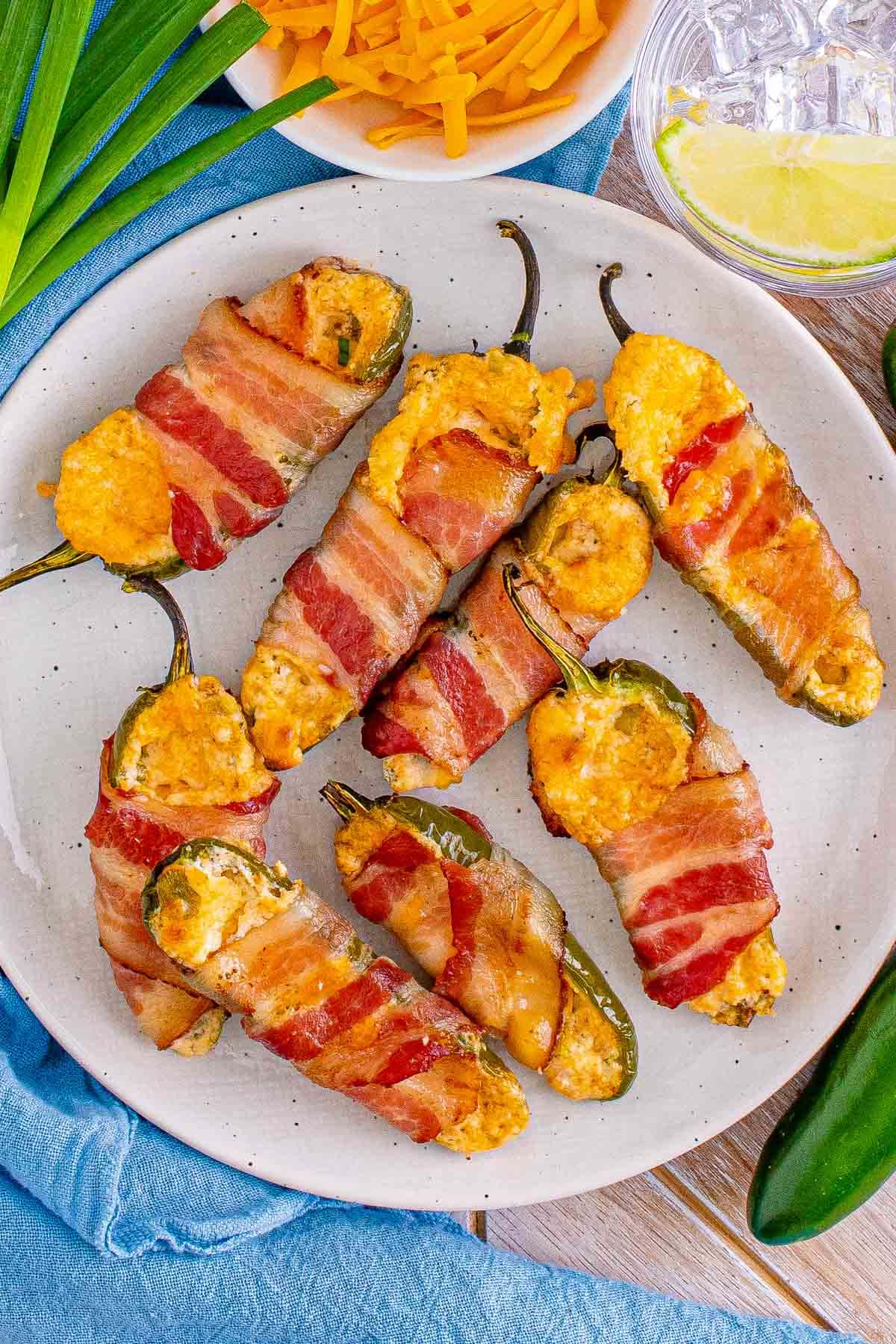 bacon wrapped jalapeno poppers on a white plate