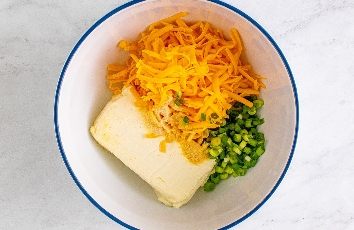 cream cheese, shredded cheddar and green onions in a large bowl