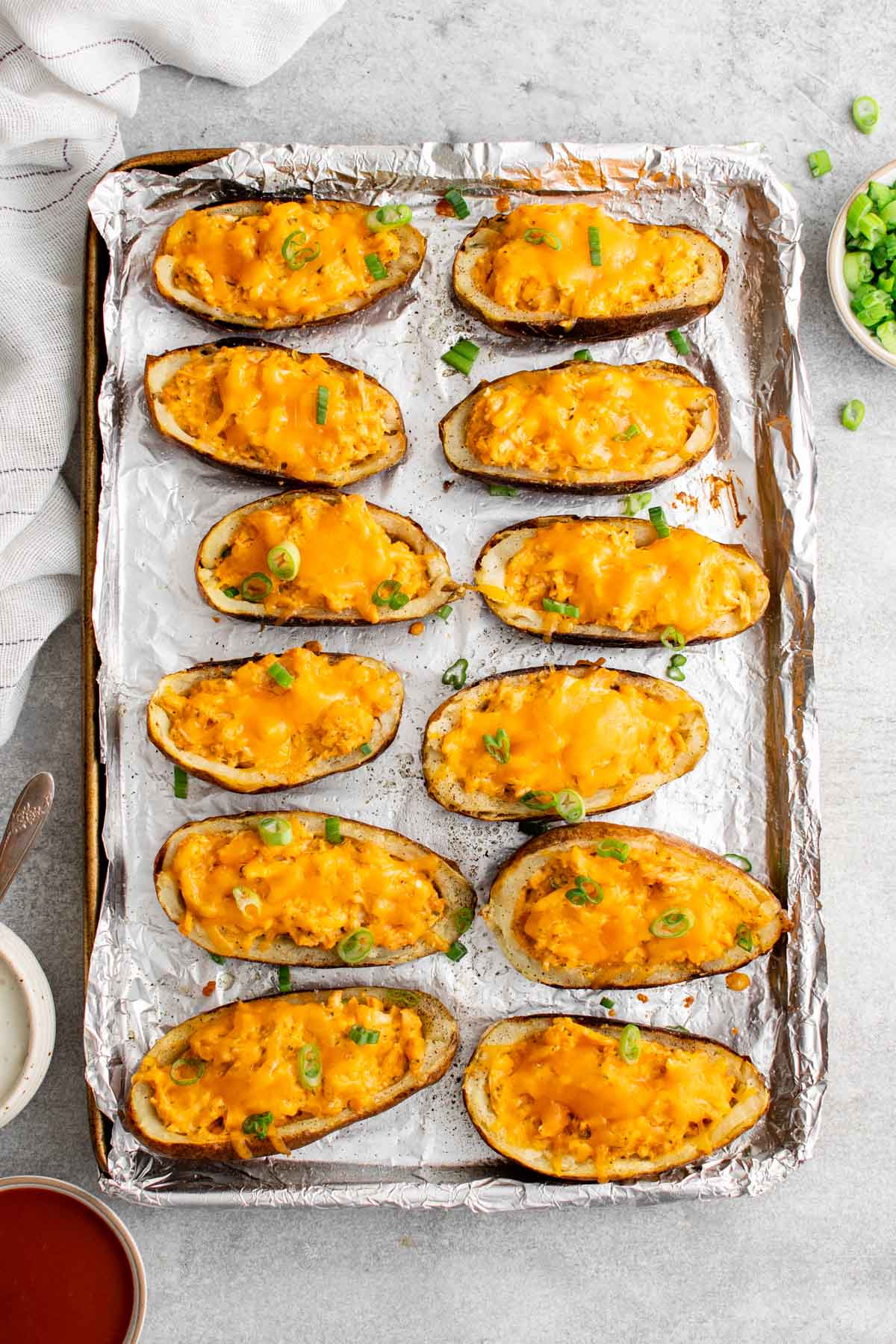 baking sheet covered with foil, baked potato skins with buffalo chicken