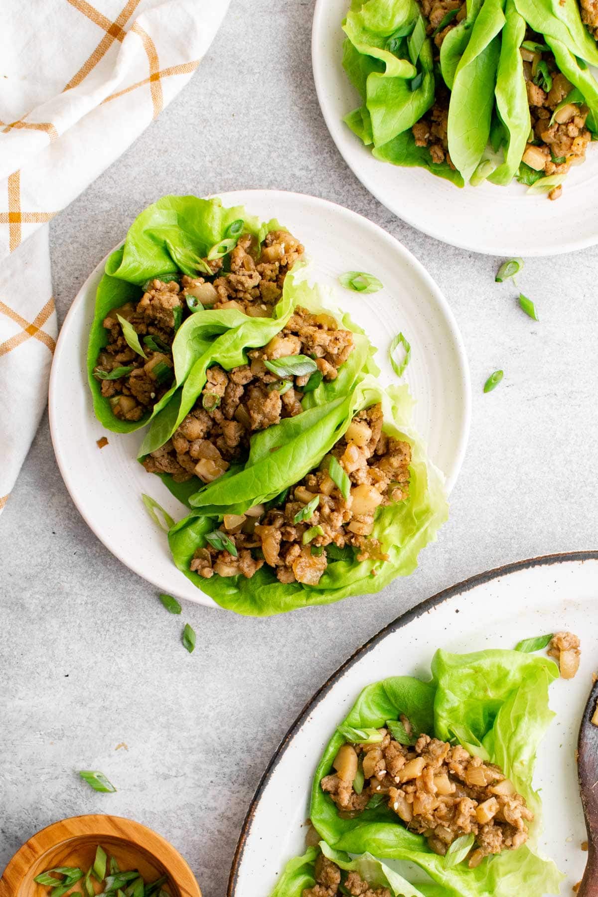 chicken lettuce wraps on white plates