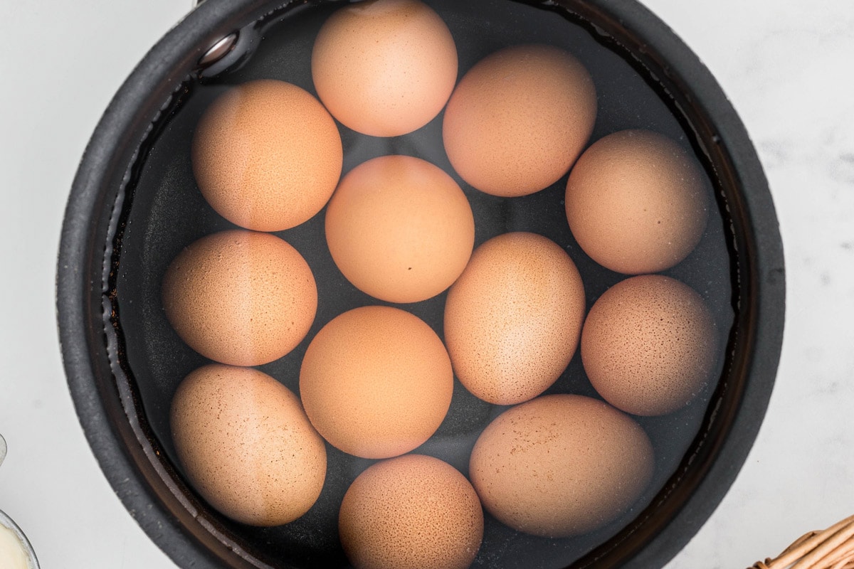 brown eggs in a pot of water