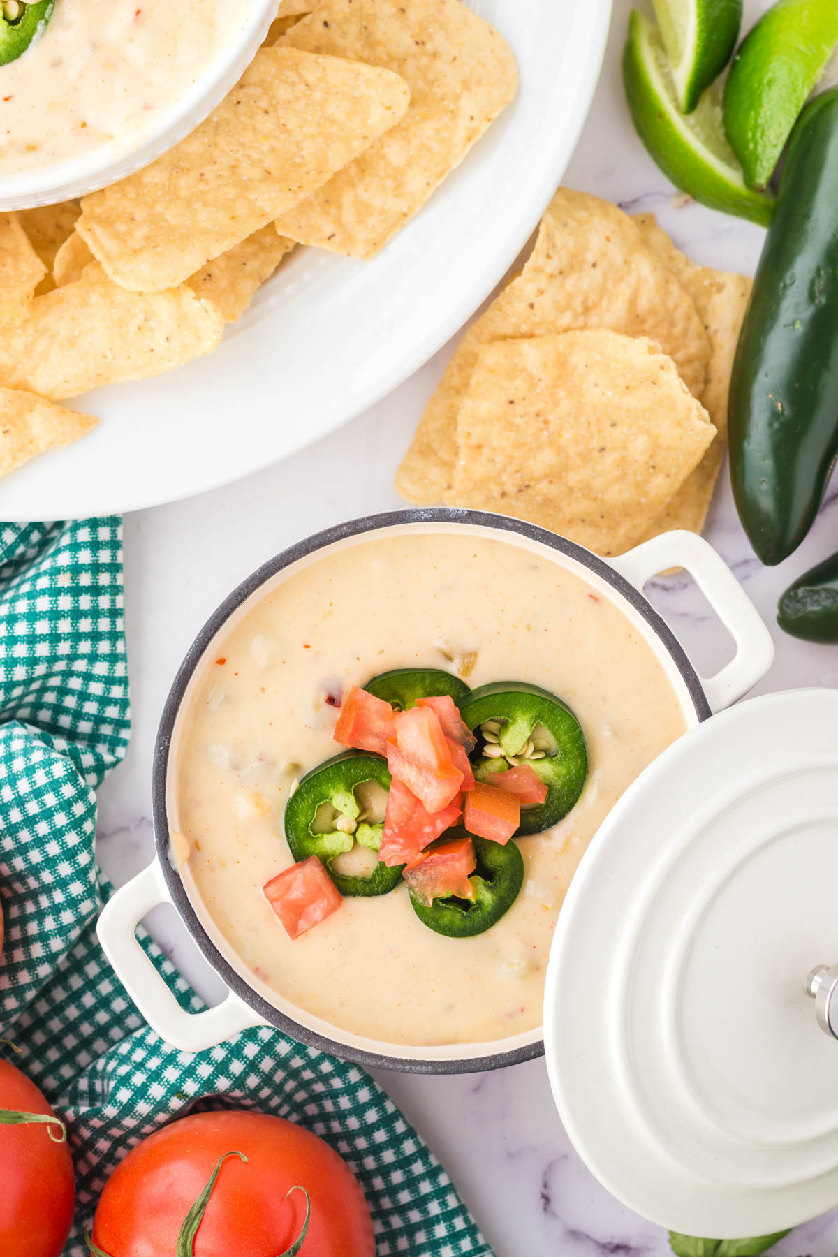 white cheese dip in a white pot, tortilla chips, vegetables