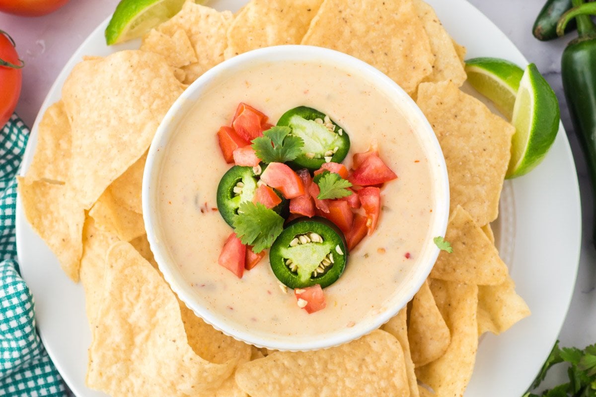 white queso dip in a dish on a platter