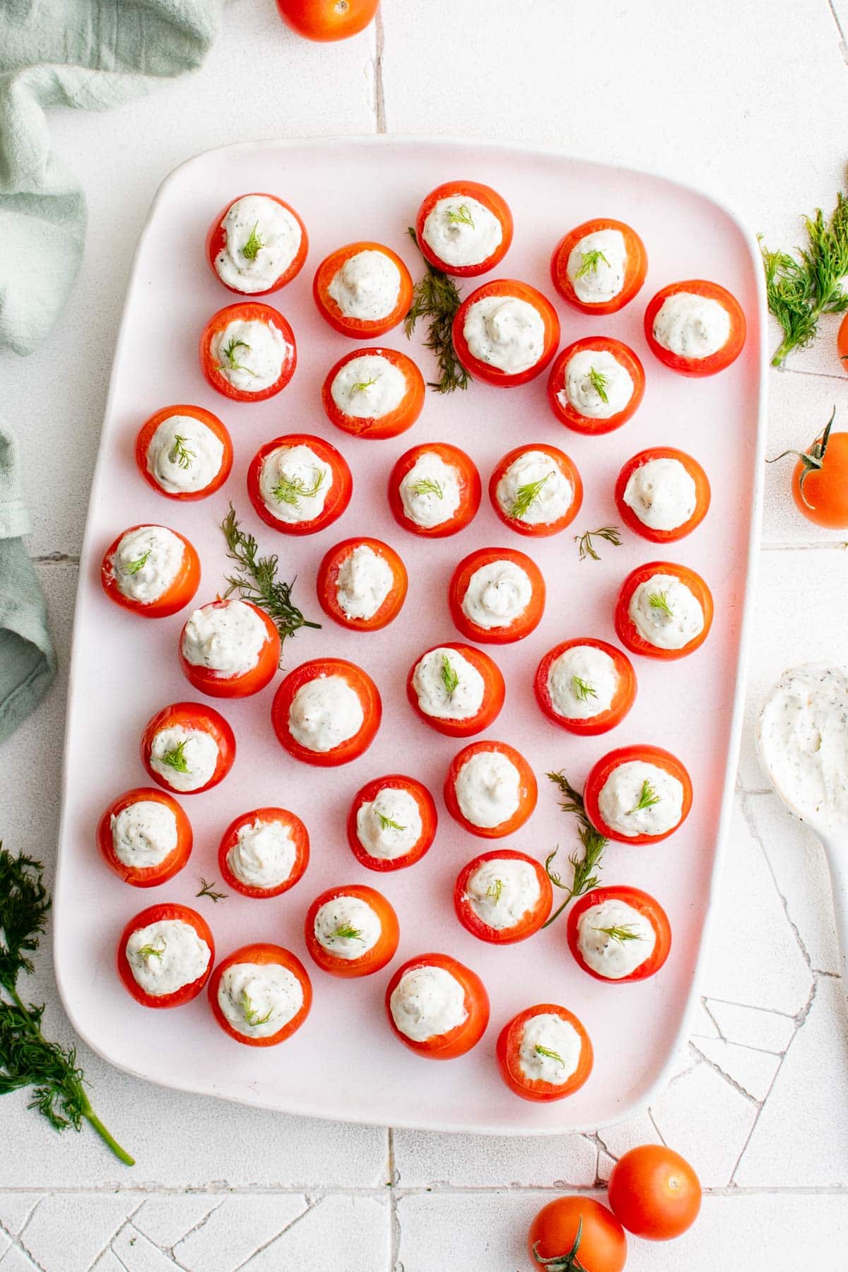 stuffed cherry tomatoes on a white platter