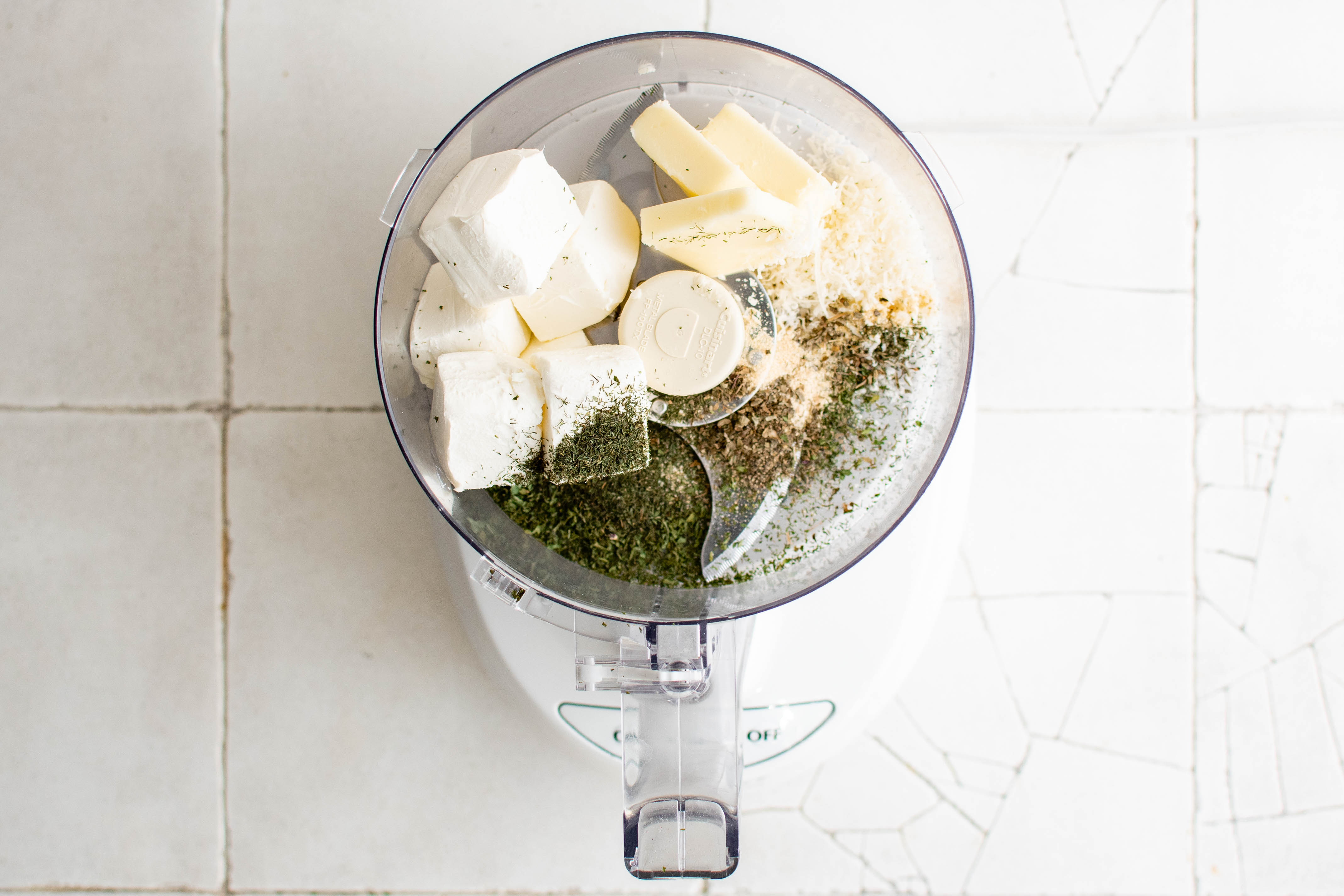cream cheese and herbs in a food processor