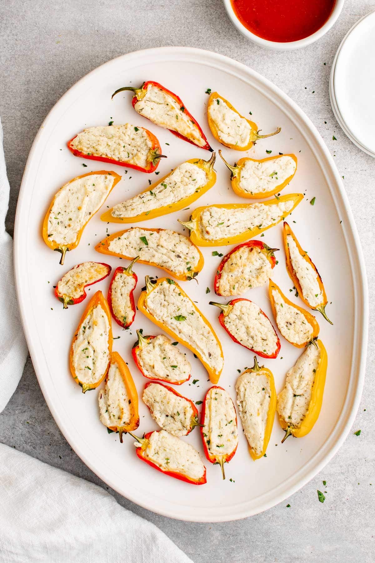 goat cheese stuffed mini peppers on a white platter