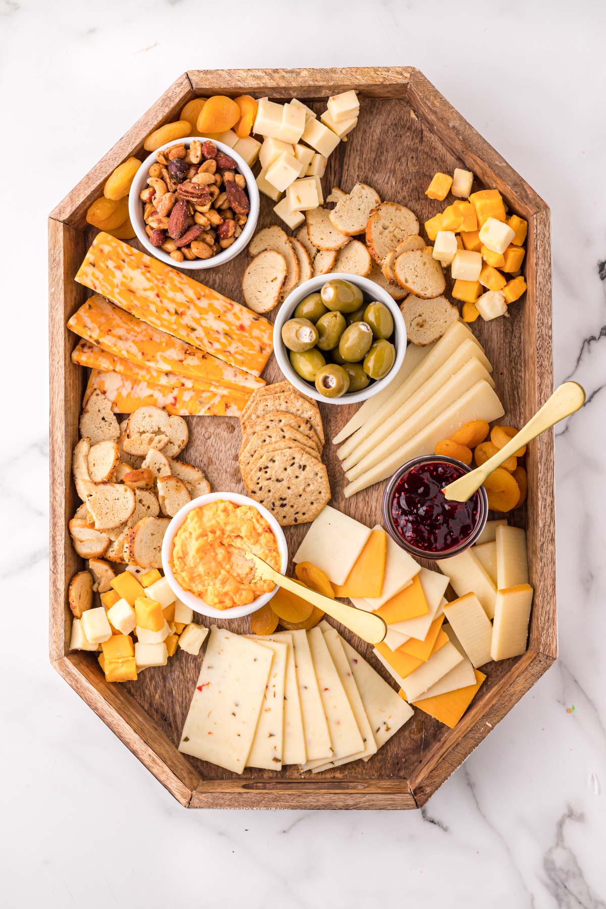 cheese board with crackers and condiments