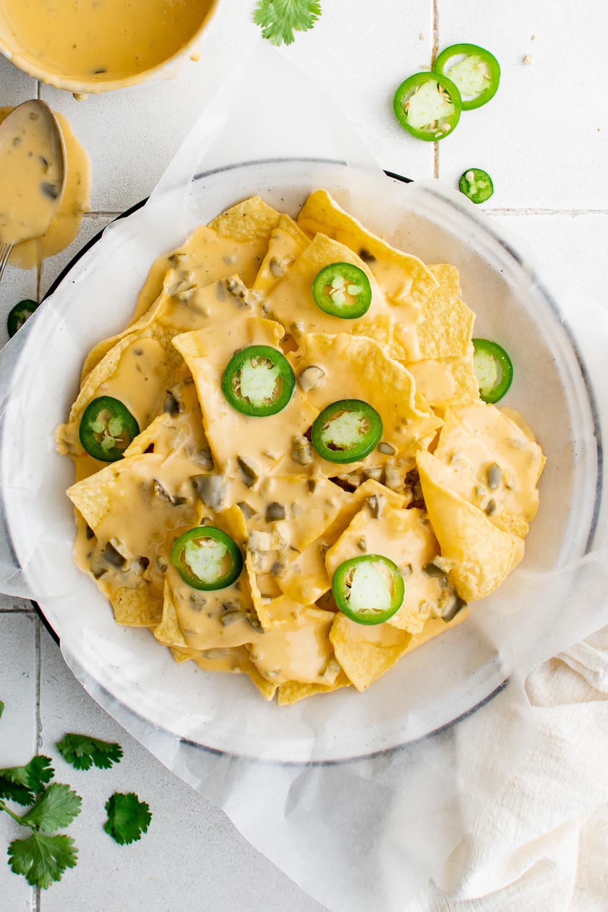 plate of nacho chips with sliced jalapenos