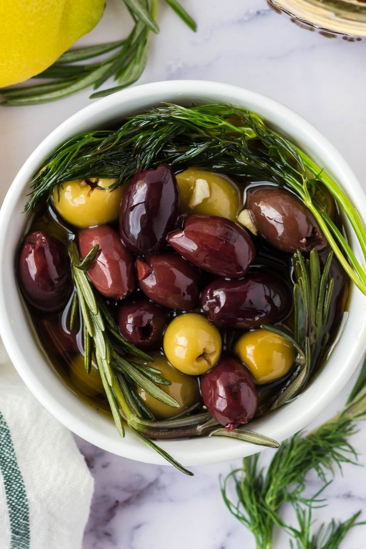 Small white bowl with marinated olives.