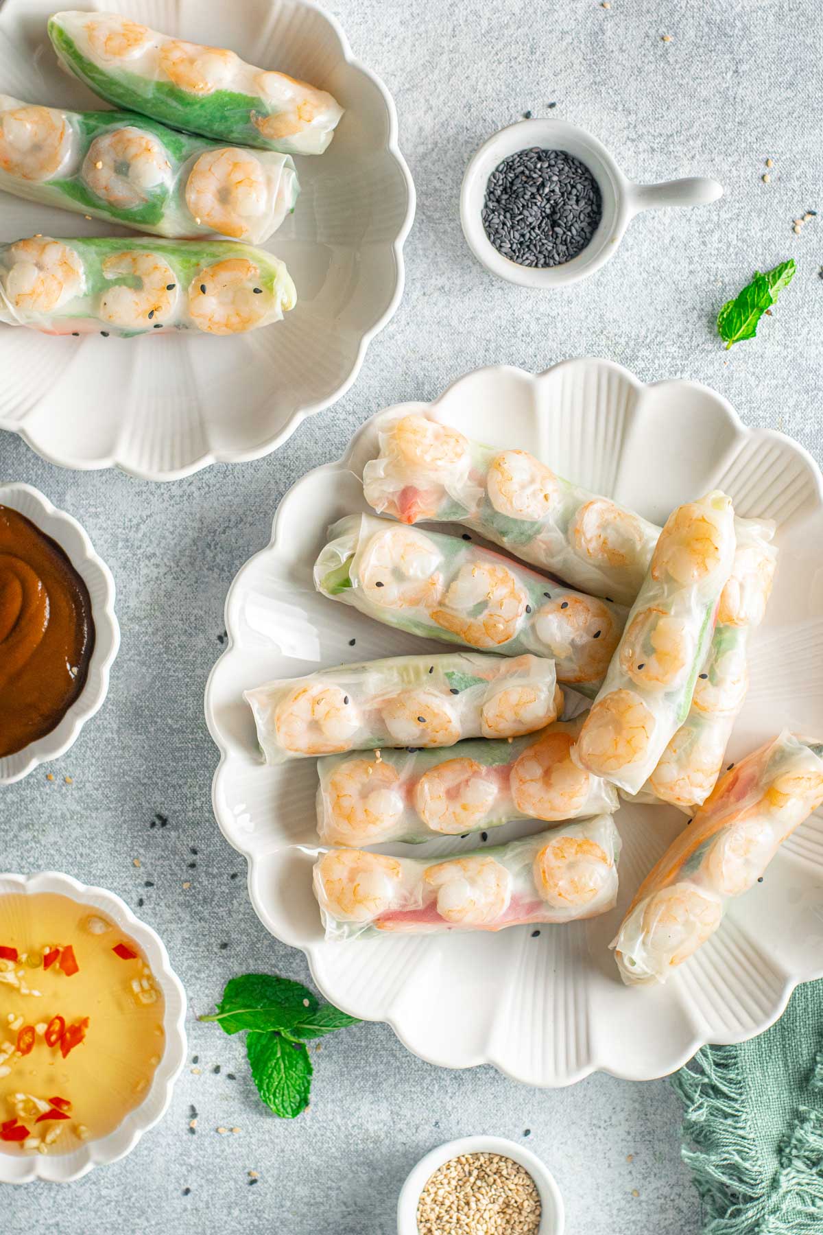 Spring Rolls on a platter with bowls of sauces surrounding them. 