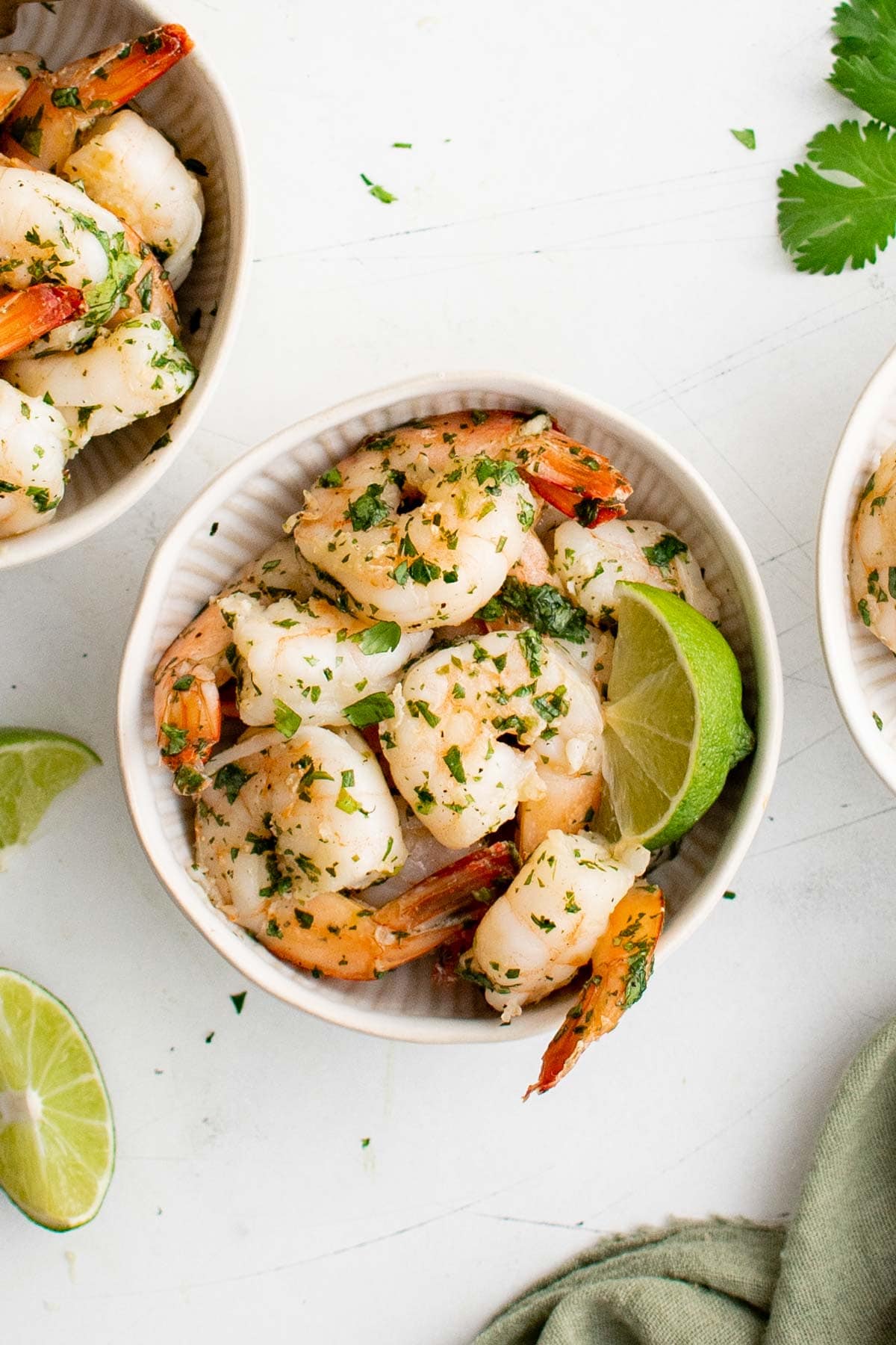 Cilantro Lime Shrimp in a small white bowl with a lime wedge. 