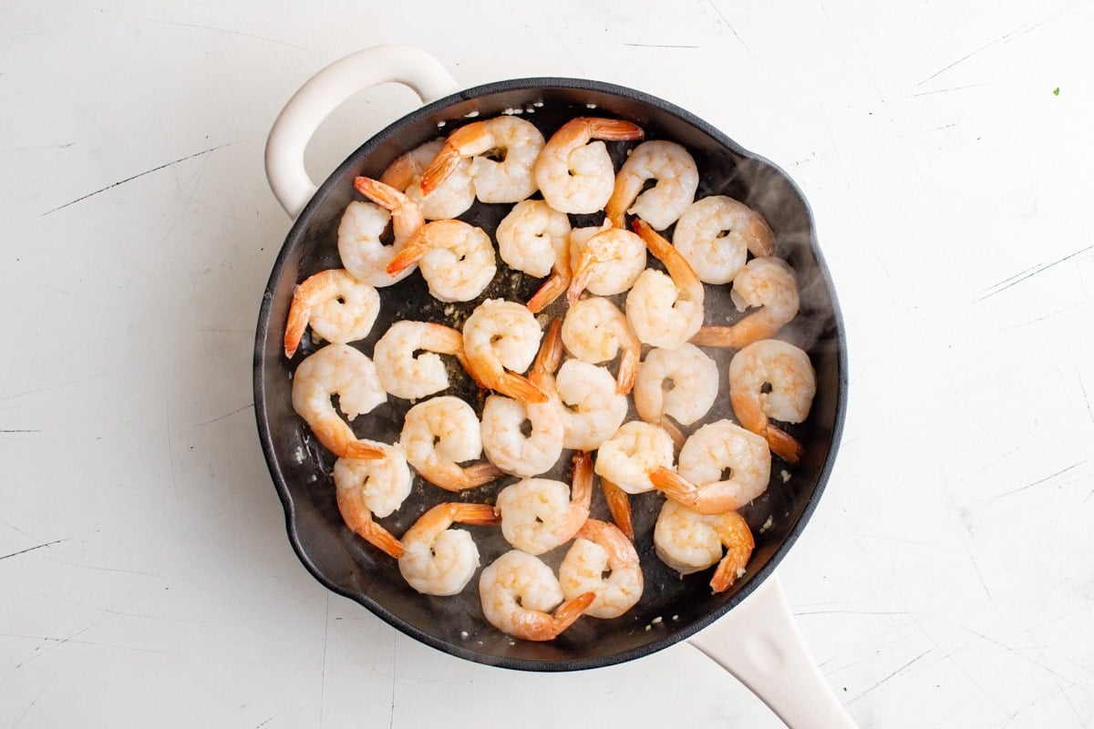 Cooked shrimp in a large skillet.