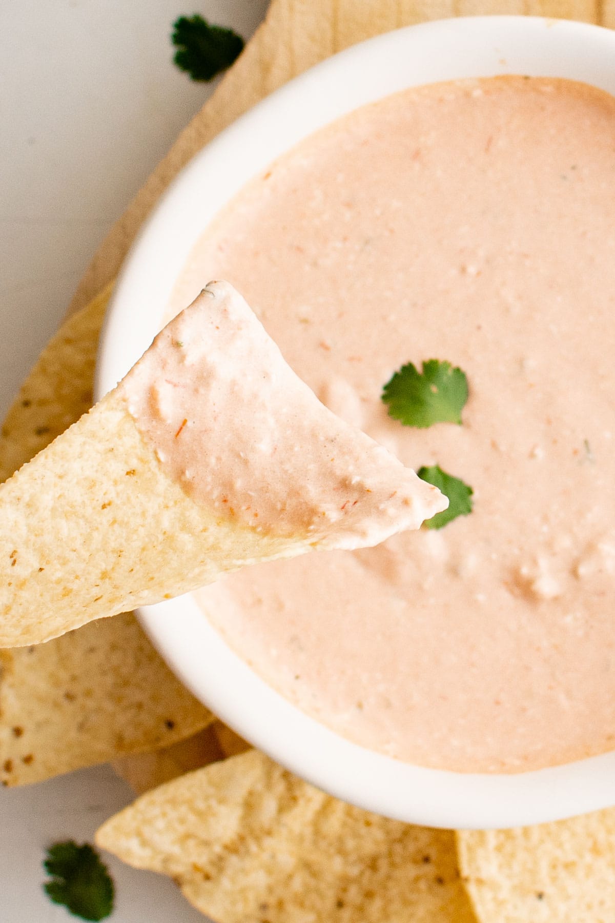cream cheese and salsa blended dip in a white bowl, tortilla chips.