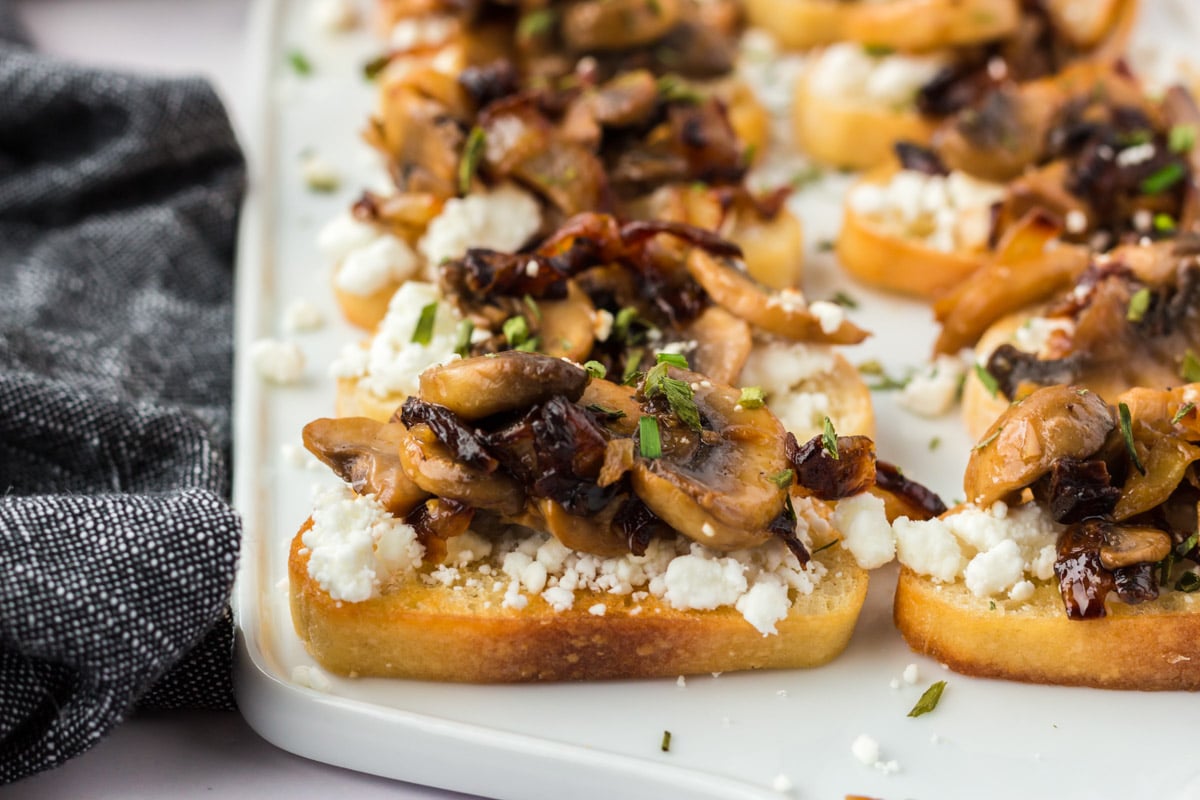 Close up image of mushroom crostini with goat cheese. 