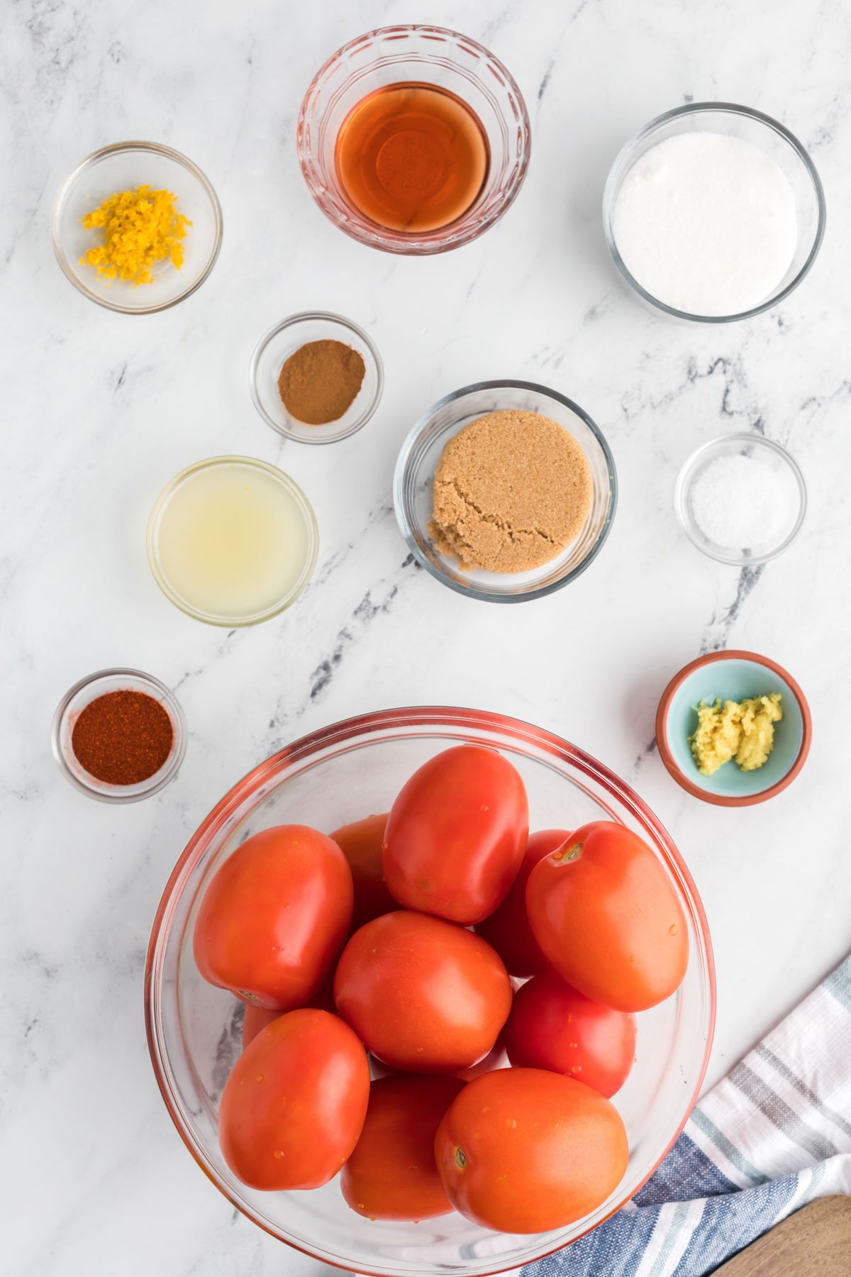 Ingredients for tomato jam on a marble background. 