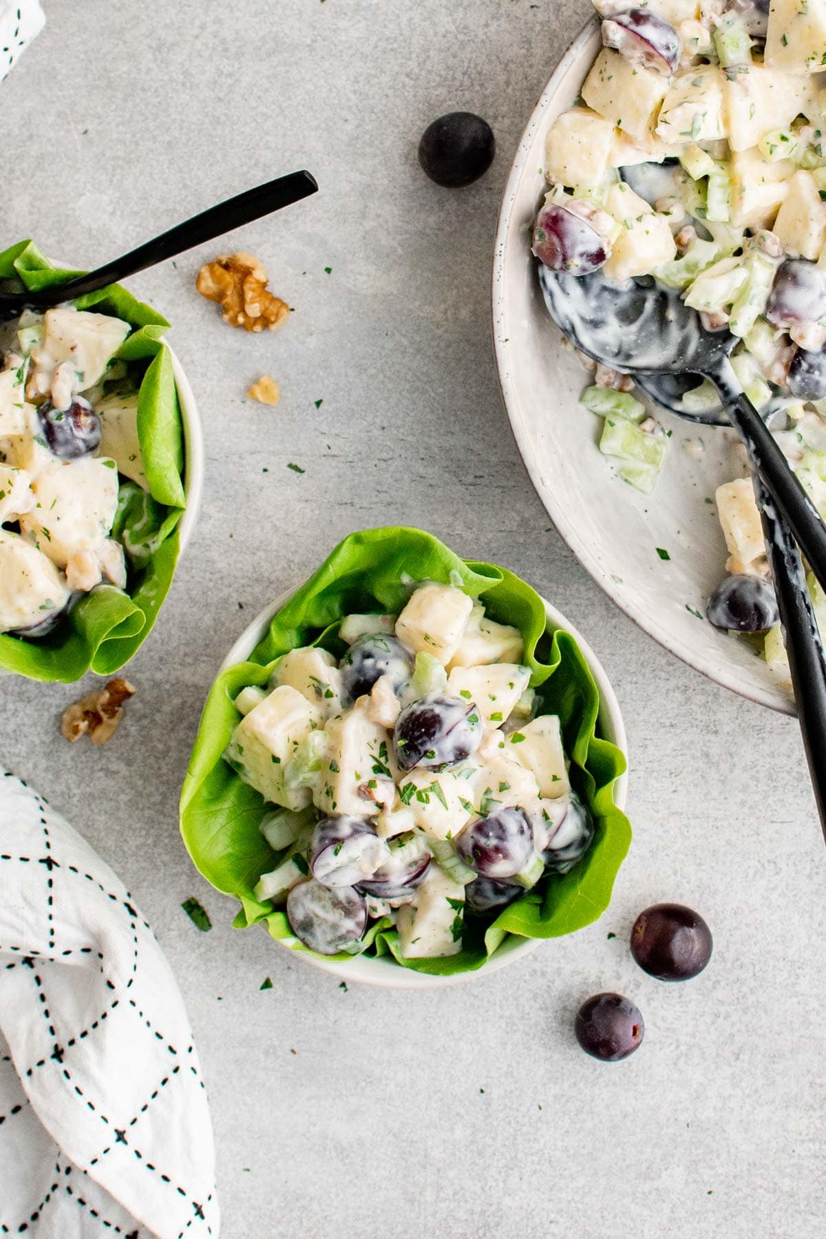 two small bowls with lettuce cups of Waldorf Salad. 