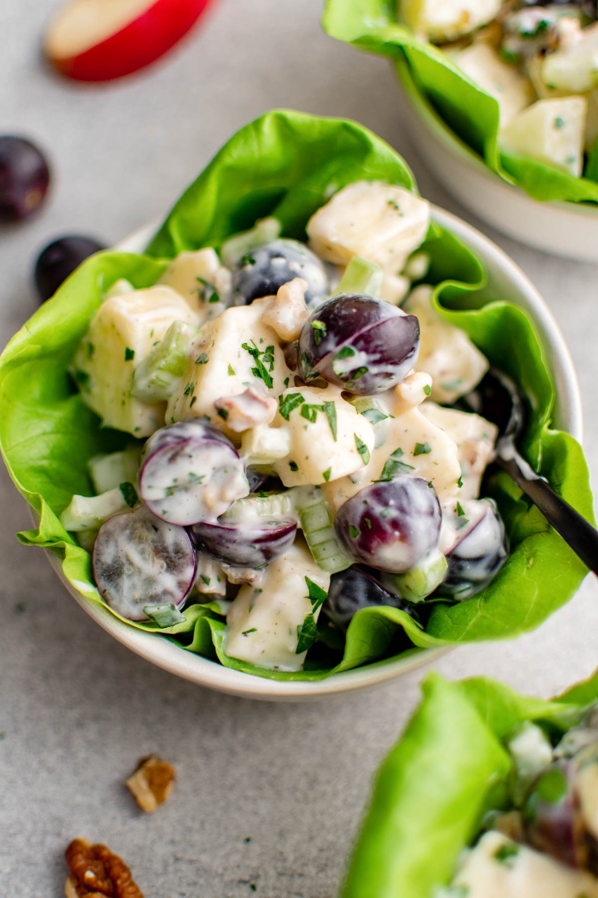 a small bowl with a lettuce cup with waldorf salad. 