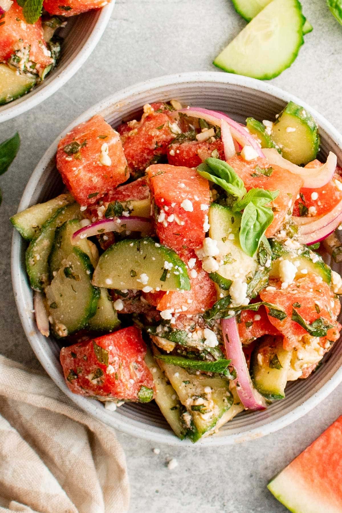 Serving bowl with watermelon, cucumbers and feta. 