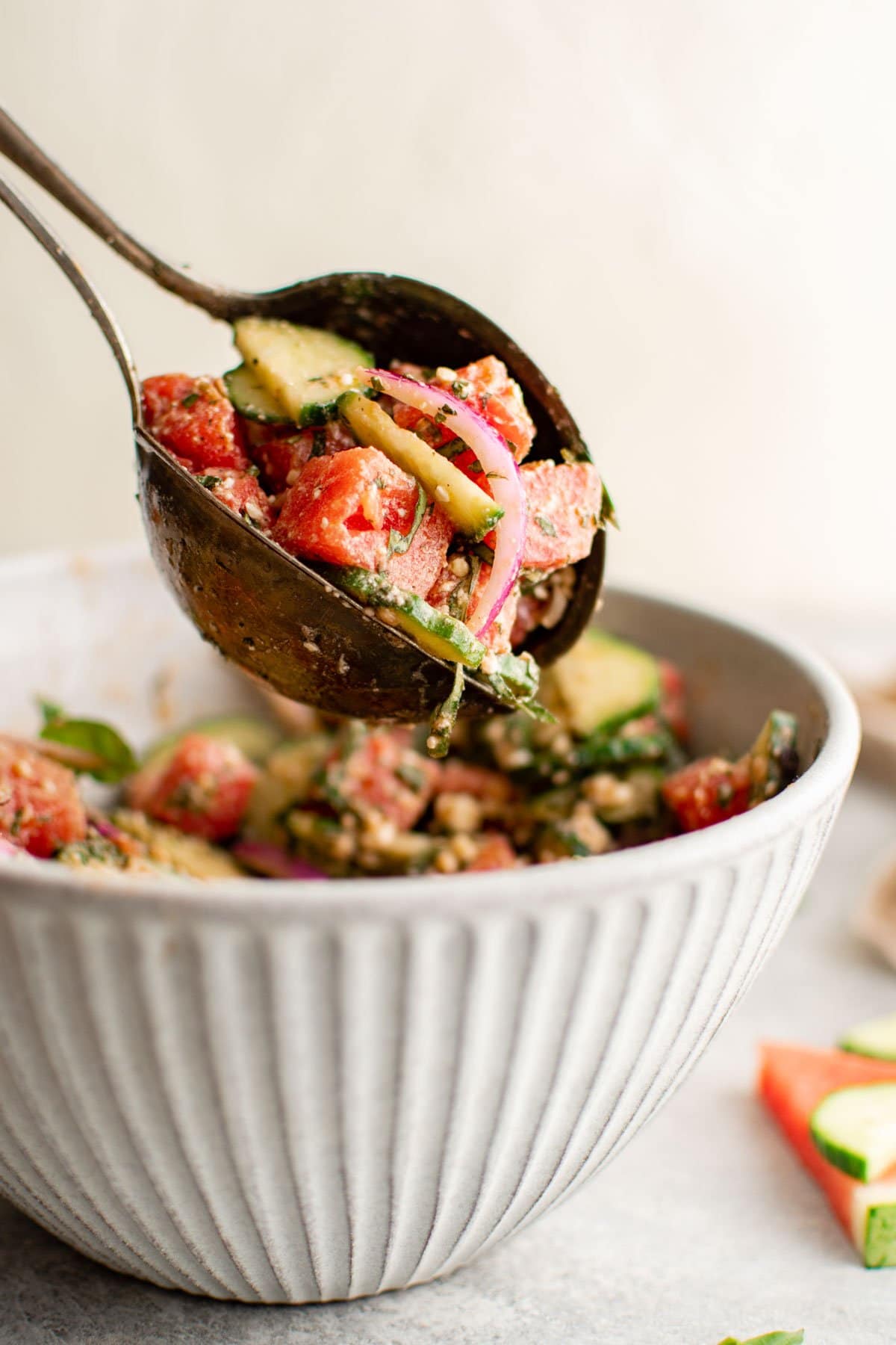 Serving spoons with watermelon cucumber salad. 
