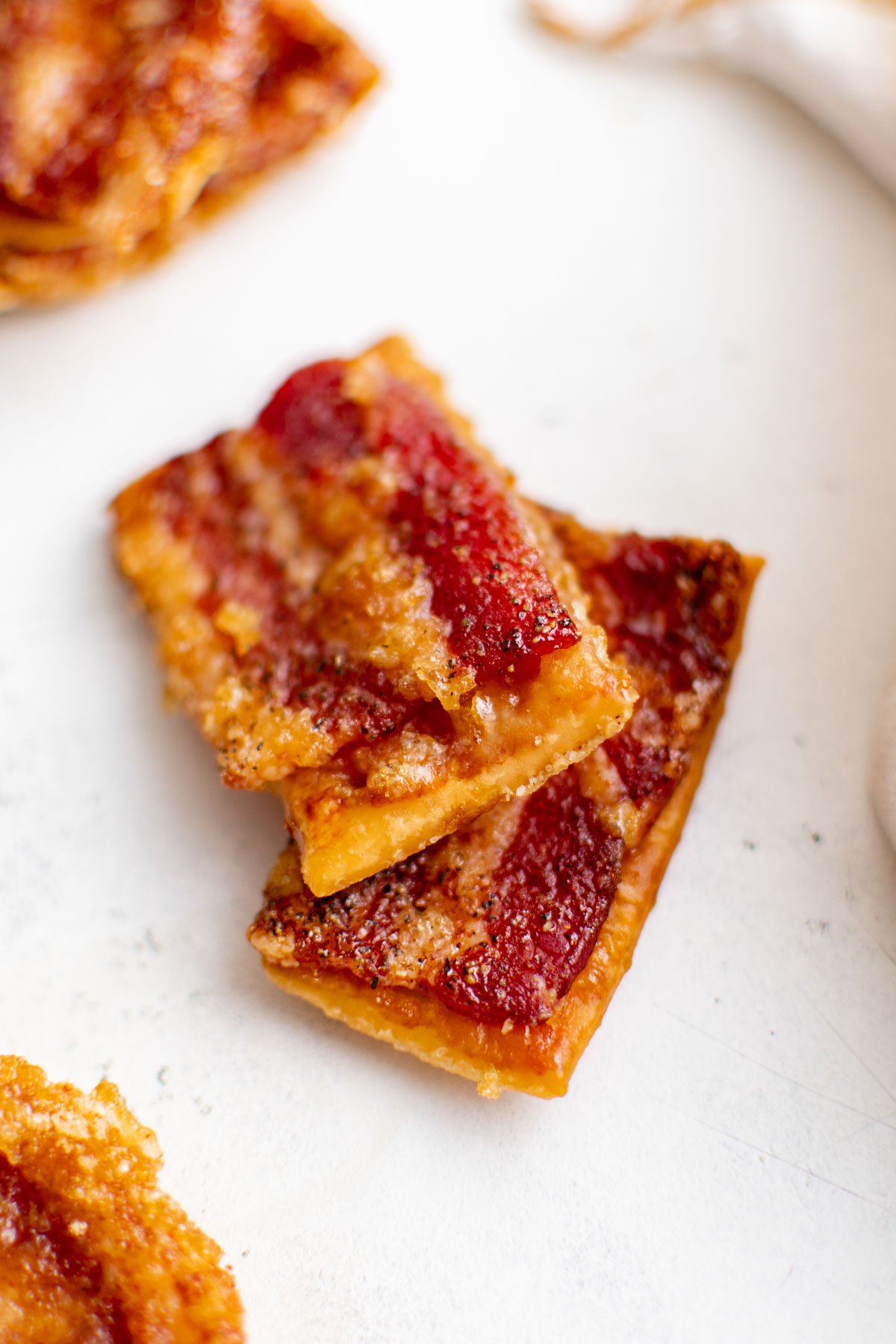 Crackers with bacon baked onto them.