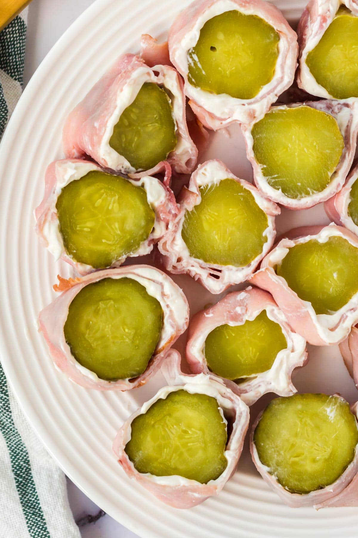 pickle slices rolled up with cream cheese and ham. 