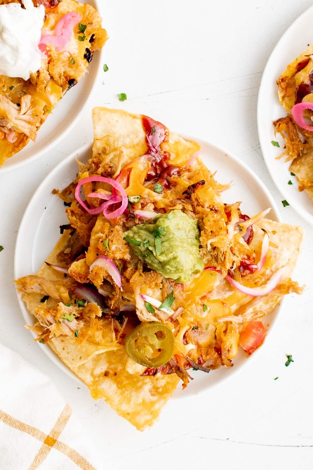Small plates with pulled pork nachos. 