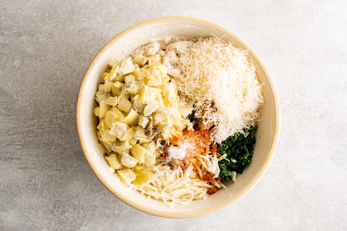 Bowl with artichokes, spinach and cheeses. 