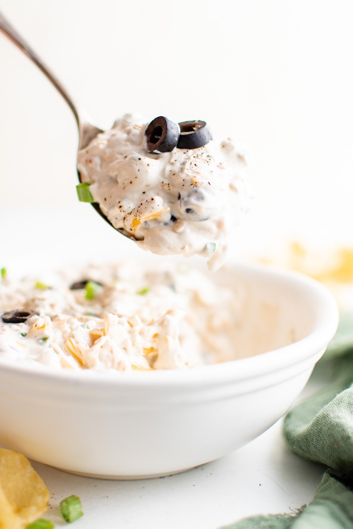 Olive dip in a bowl and on a spoon.