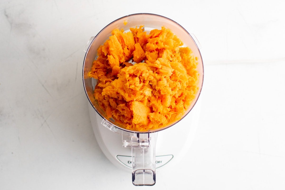 Mashed sweet potato in a food processor.