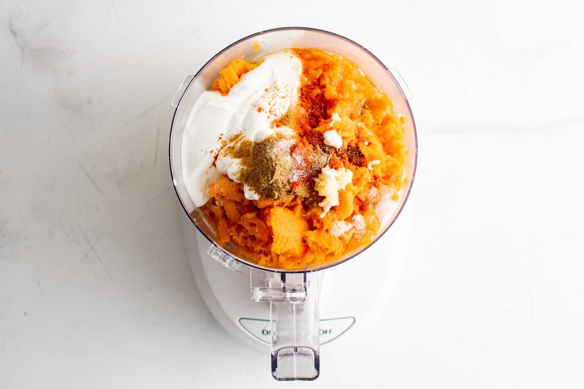 Mashed sweet potato and seasonings in a food processor.